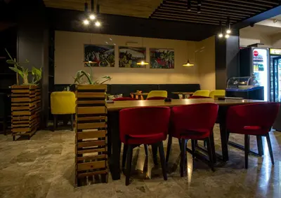 a dining room with a table and red chairs at HOTEL Villa Grande in Bugojno