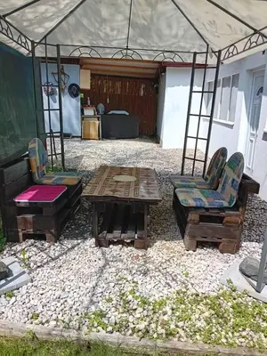 a patio with two chairs and a table and a tent at Ravne Apartman in Visoko