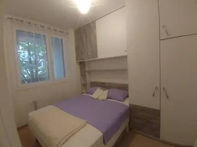 a small bedroom with a bed and a window at Apartman Ladybug in Banja Luka