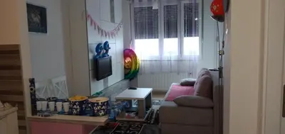 a living room with a couch and a table at Apartman Ladybug in Banja Luka