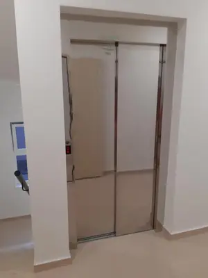 a closet with a glass door in a room at Apartman Ladybug in Banja Luka