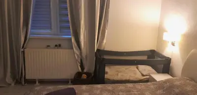 a small bedroom with a bed and a window at VISOKO COMFORT suite in Visoko