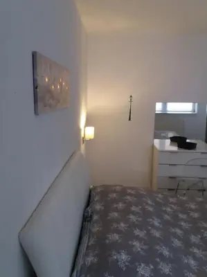 a small bedroom with a bed and a dresser at VISOKO COMFORT suite in Visoko