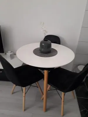 a black hat sitting on a white table with two chairs at VISOKO COMFORT suite in Visoko