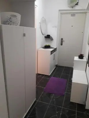 a small kitchen with a purple rug on the floor at VISOKO COMFORT suite in Visoko