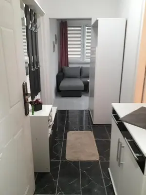 a kitchen with a living room with a couch at VISOKO COMFORT suite in Visoko