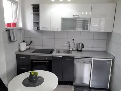 a small kitchen with a sink and a table at VISOKO COMFORT suite in Visoko