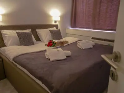 a large bed with two towels on top of it at Hotel Slavija Banja Luka in Banja Luka