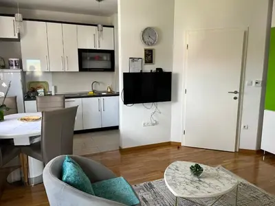 a living room with a kitchen and a dining room at Relax Teslić in Teslić