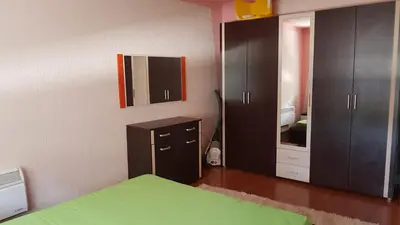 a bedroom with a bed and a mirror and cabinets at Sana apartment in Sanski most
