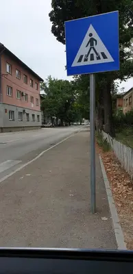 a blue sign on the side of a road at Sana apartment in Sanski most