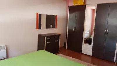 a bedroom with a bed and a dresser and a mirror at Sana apartment in Sanski most