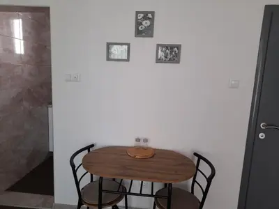 a wooden table and chairs in a room at Irma in Tuzla