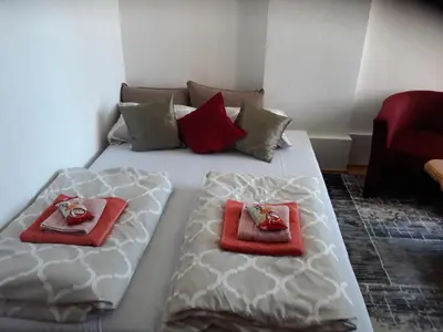 a large white bed with two towels on it at Irma in Tuzla