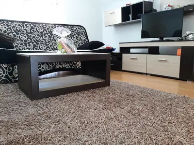 a living room with a couch and a tv at City Apartment in Visoko