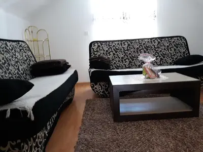 a living room with two couches and a table at City Apartment in Visoko