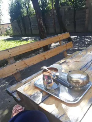a picnic table with a tray of food on a bench at City Apartment in Visoko