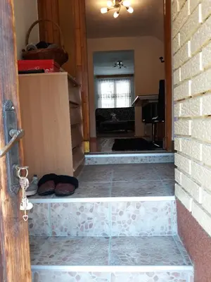 a hallway of a house with a brick wall at City Apartment in Visoko