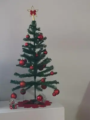 a christmas tree with ornaments on a table at Apartman Taša in Banja Luka