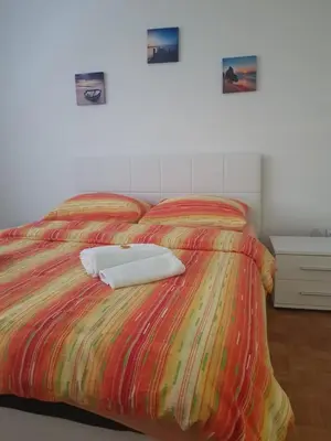 a bedroom with a bed with two towels on it at Apartman Taša in Banja Luka