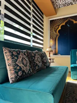a blue couch in a room with a window at APARTMENTS VRANAS in Visoko