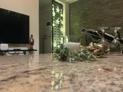 a table with a candle and flowers on it at APARTMENTS VRANAS in Visoko