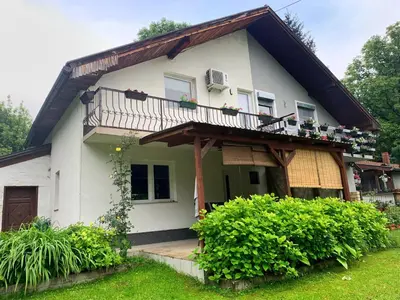 a house with a balcony on top of it at Holiday Residence Burić in Visoko
