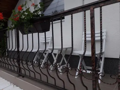 a white chair on a balcony with a plant at Holiday Residence Burić in Visoko