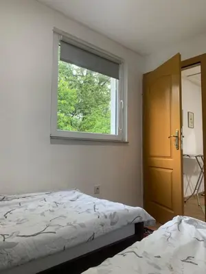a bedroom with a bed and a window at Holiday Residence Burić in Visoko