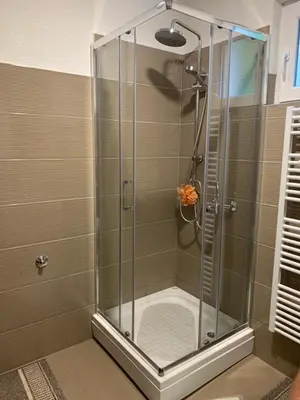 a shower with a glass door in a bathroom at Holiday Residence Burić in Visoko