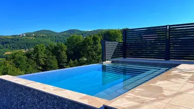 a swimming pool with a view of the mountains at Villa Queen in Visoko