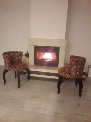 two chairs sitting in front of a fireplace at Villa Queen in Visoko