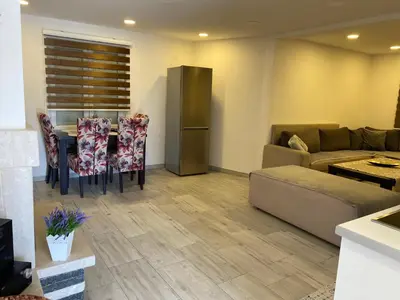 a living room with a table and a couch at Villa Queen in Visoko