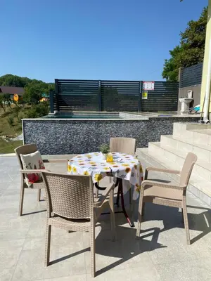 a table and chairs sitting on a patio at Villa Queen in Visoko