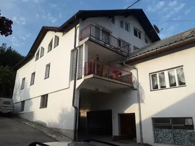 a white building with a balcony on the side at Motel Tetrijeb Sipovo in Šipovo