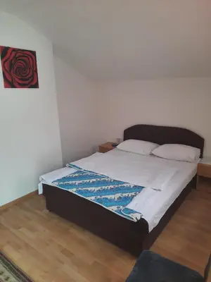 a bedroom with a large bed with white sheets at Motel Tetrijeb Sipovo in Šipovo