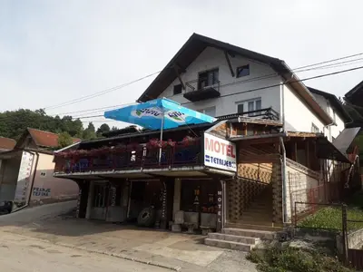a store with an umbrella in front of a building at Motel Tetrijeb Sipovo in Šipovo
