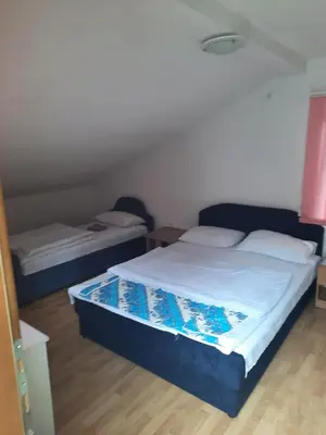 a bedroom with two beds in a room at Motel Tetrijeb Sipovo in Šipovo