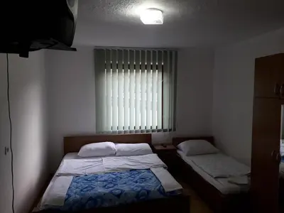 a bedroom with two beds and a window at Motel Tetrijeb Sipovo in Šipovo