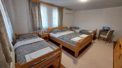 a room with three beds and a television in it at Panorama Travnik in Travnik