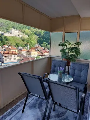 a table and chairs on a balcony with a view at Panorama Travnik in Travnik