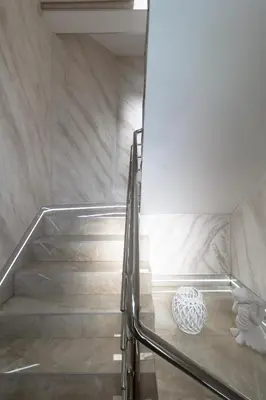 a staircase in a building with a vase on the floor at Motel Atos in Laktaši