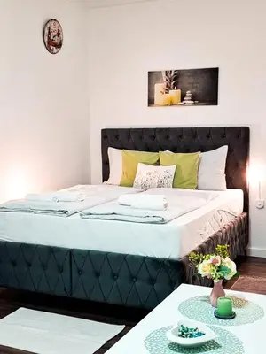 a bed with a black headboard in a room at Helly's apartman - self check-in - in Jajce