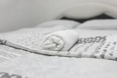 a towel is sitting on the edge of a bed at Helly's apartman - self check-in - in Jajce