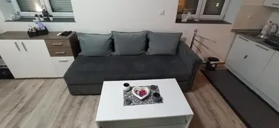 a living room with a couch and a table at Helly's apartman - self check-in - in Jajce