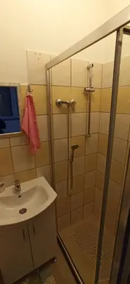 a bathroom with a shower and a sink at Helly's apartman - self check-in - in Jajce