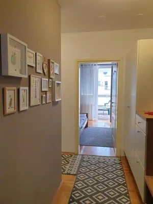 a hallway with a door leading to a living room at Stan na dan 