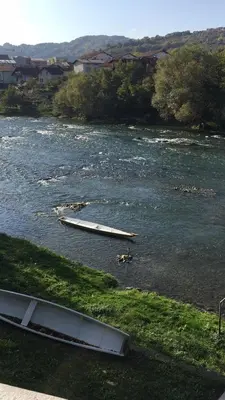 a river with several boats in the water at Excellency apartmani in Banja Luka