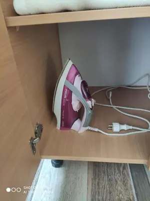 a iron sitting inside of a drawer at Excellency apartmani in Banja Luka