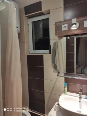 a bathroom with a sink and a window at Excellency apartmani in Banja Luka